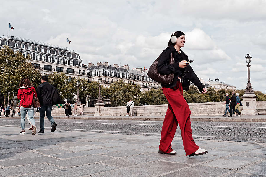 A woman in black and red on the Pont Neuf in Paris